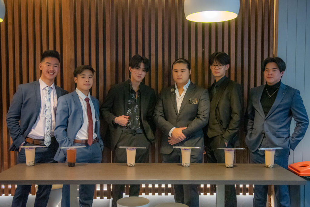 high school teen boys posing before formal at boba shop with bubble tea drinks